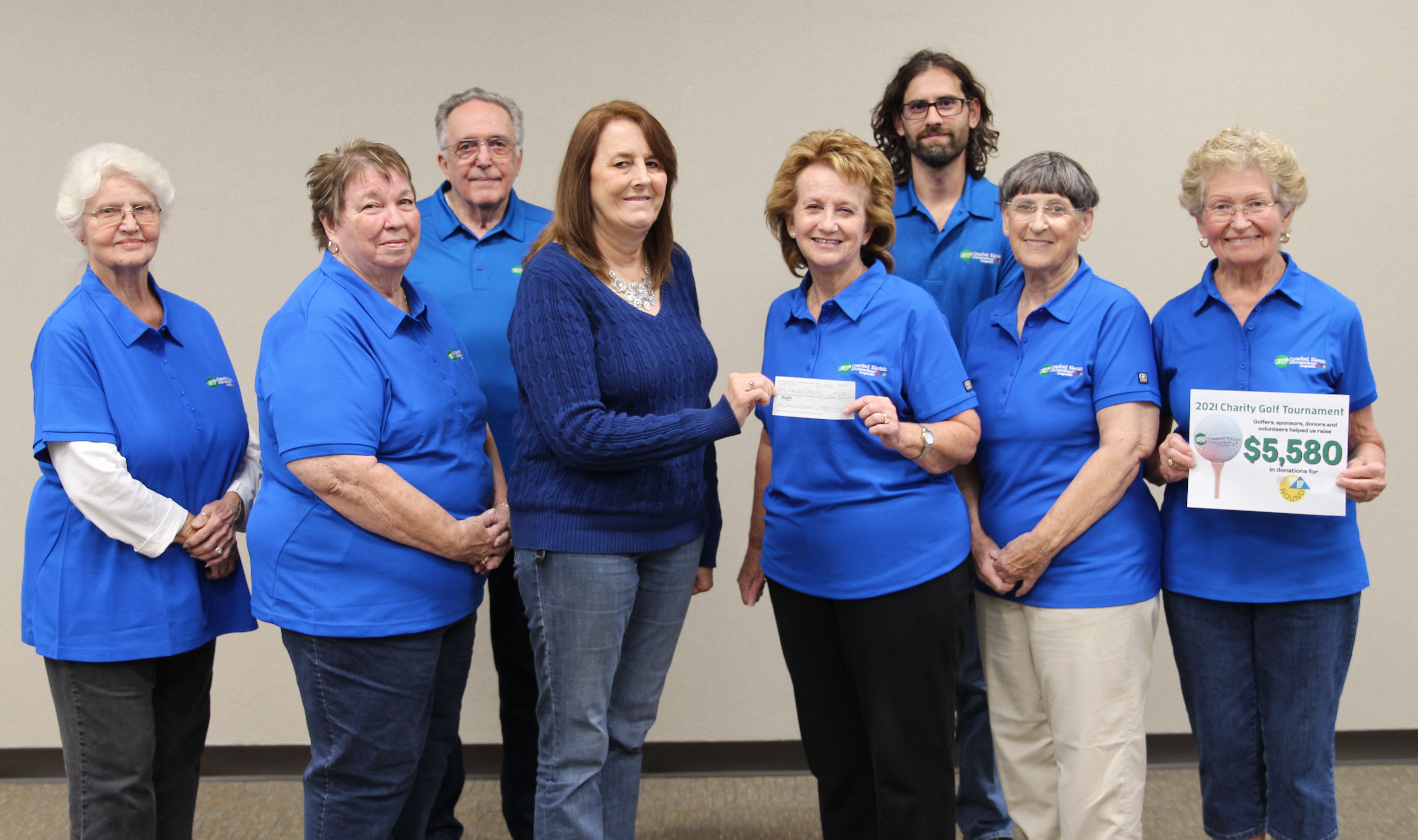 Members of Charitable Trust Board receive donation check from golf tournament